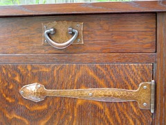 Detail hand hammered copper drawer pull and door strap.